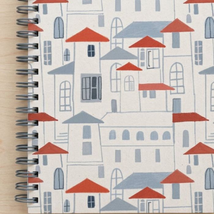 A spiral-bound notebook covered in the Destination California hillside town repeat.